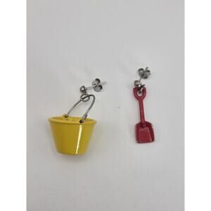Beach-themed mismatch earrings featuring miniature yellow bucket and red shovel